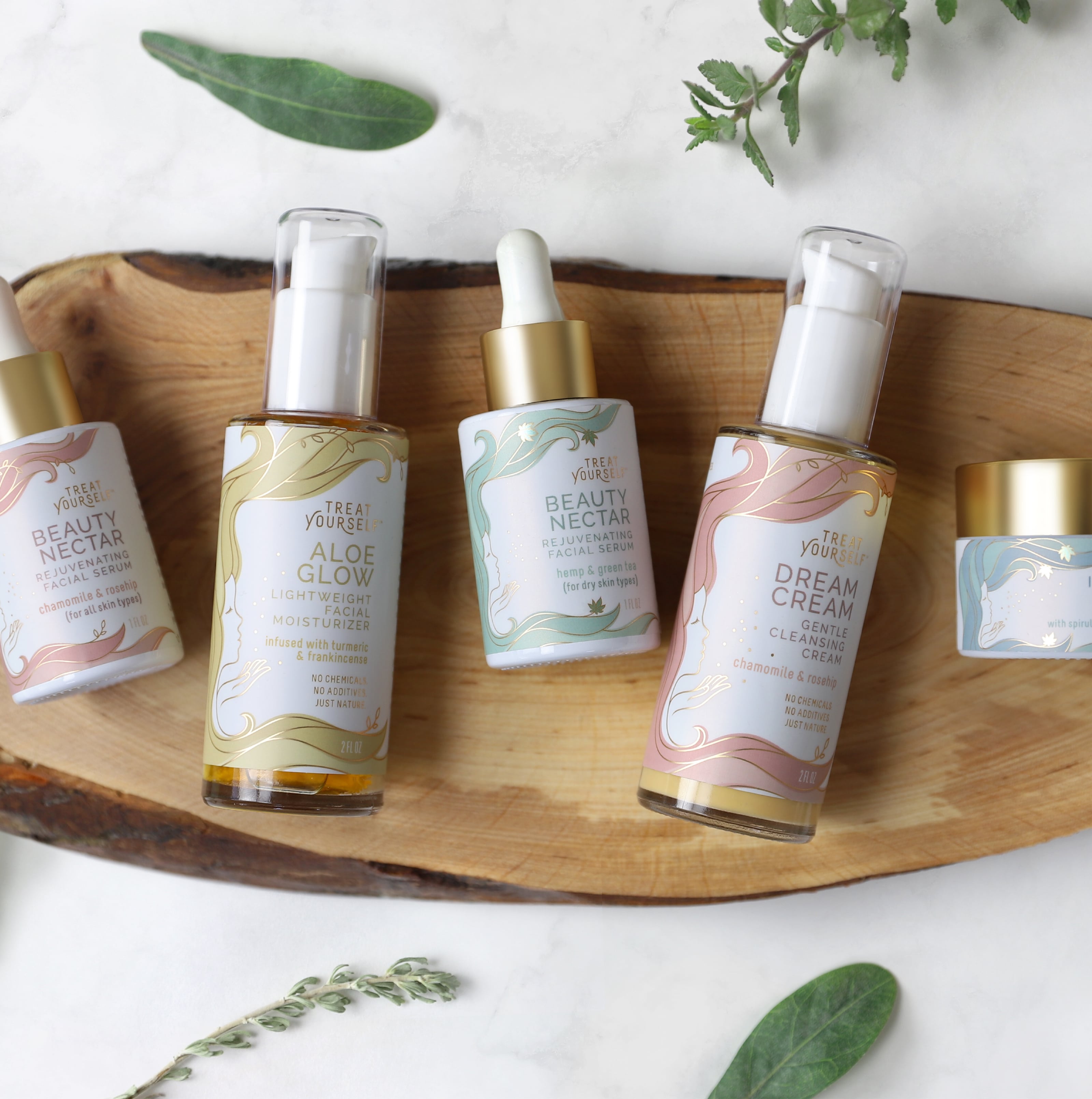 Range of wellness and cannabis products laying on natural wood with leaves